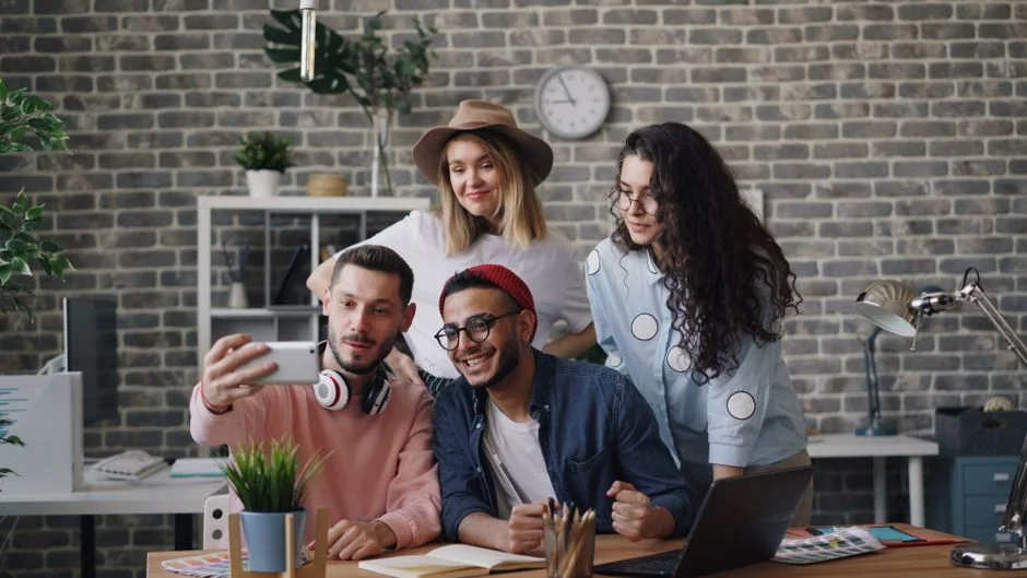 Group of designers collaborating in modern office space with computer.